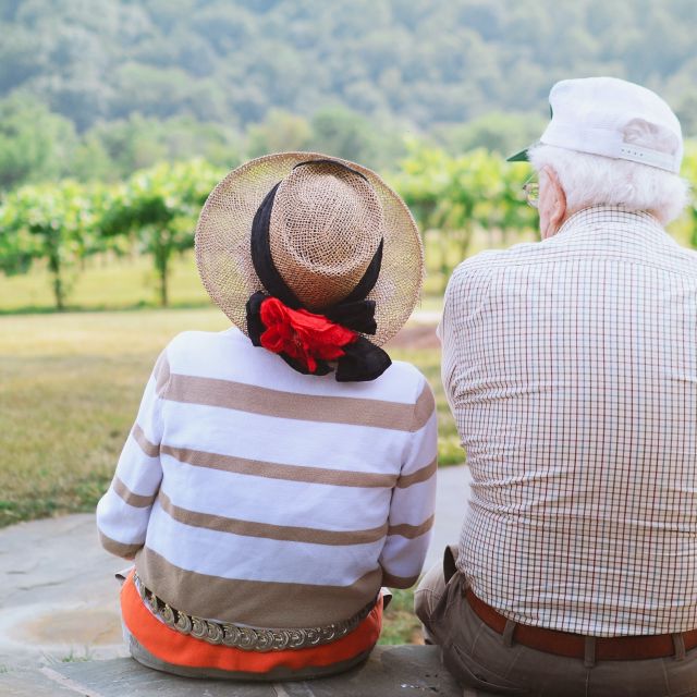 Älteres Paar sitzt in der Natur; Negativzinsen: Die staatliche Deutsche Rentenversicherung muss Millionen zahlen